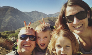 family on vacation with son giving bunny ears